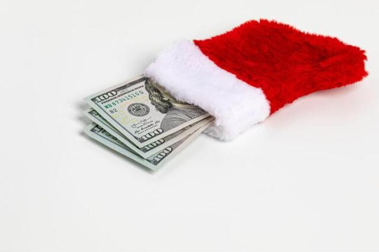 Cash gift of 100 dollar bills in Christmas stocking. 