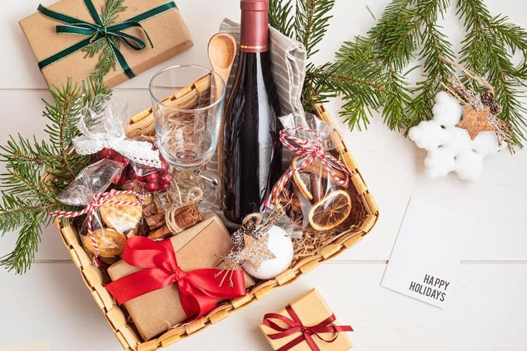 Refined Christmas gift basket for culinary enthusiats with bottle of wine and mulled wine ingredients. Corporate hamper or personal present for cooking lovers, foodies and gourmands. Refined Christmas gift basket for culinary enthusiats with bottle of wine and mulled wine ingredients. Corporate hamper or personal present for cooking lovers, foodies and gourmands.
