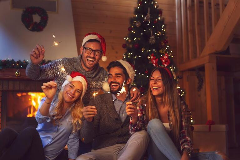 Group of young people having fun at a New Year celebration, held sparkling at a midnight countdown Group of young people having fun at a New Year celebration, held sparkling at a midnight countdown