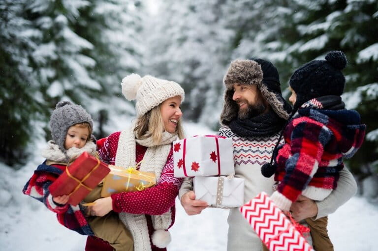 Portrait of family with two small children in winter nature, Christmas concept.