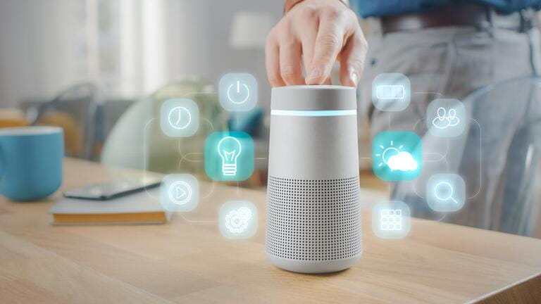 Man Turns On Smart Speaker with Active Artificial Intelligence Assistant with Futuristic Screenless Interface with Different Icons and Symbols. Man Turns On Smart Speaker with Active Artificial Intelligence Assistant with Futuristic Screenless Interface with Different Icons and Symbols.