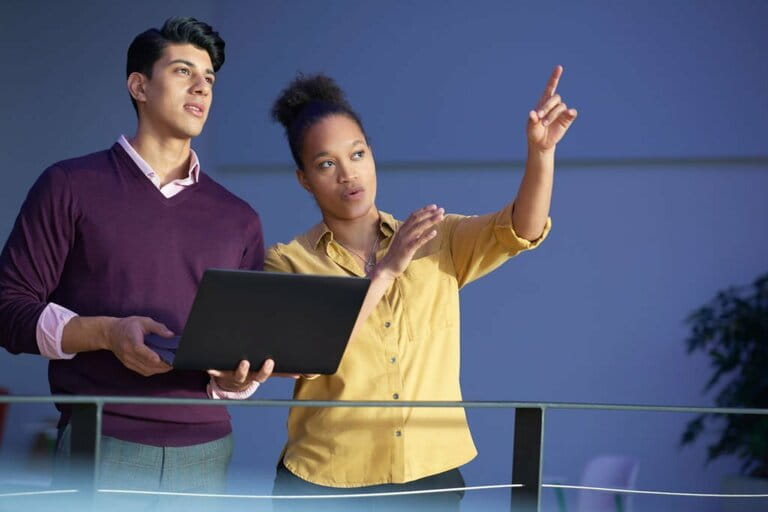 Two people examining building Two people examining building