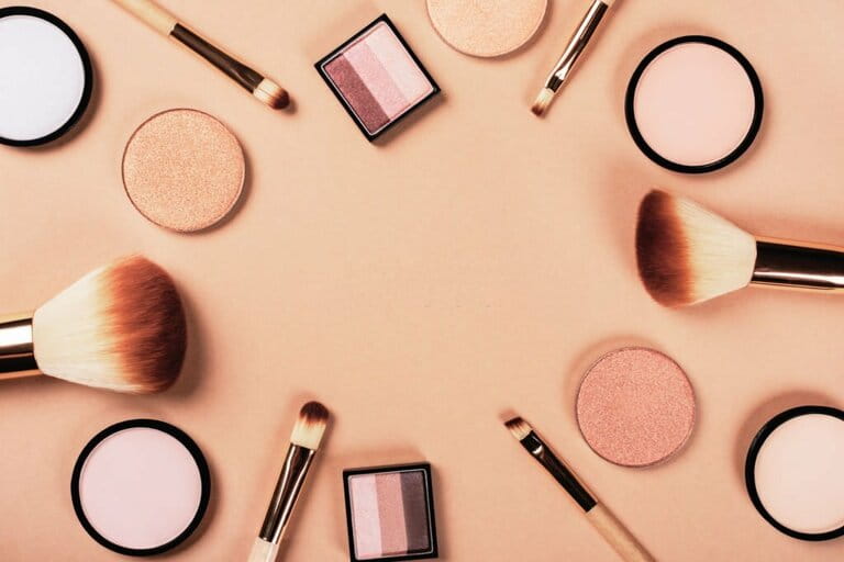 Set of different makeup accessories on beige, brown background. Cosmetic products for skin care. Eyeshadow, blush, face powder, brushes. Set of different makeup accessories on beige, brown background. Cosmetic products for skin care. Eyeshadow, blush, face powder, brushes.