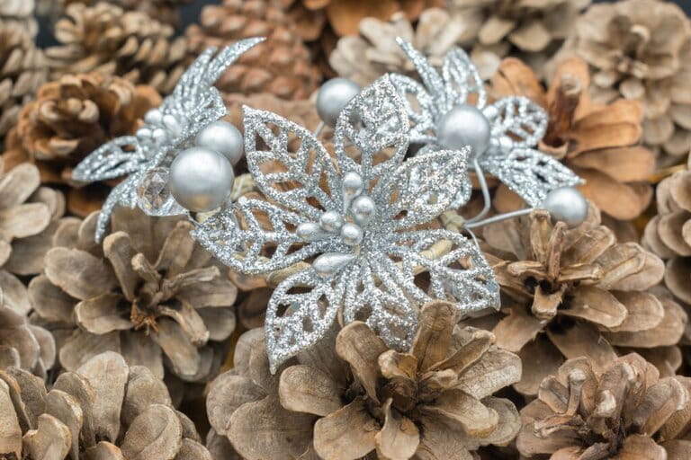 Silver Christmas floral decorations among the pinecones. Silver Christmas floral decorations among the pinecones.