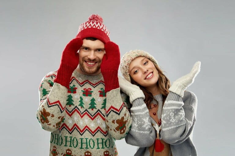 Happy couple at Christmas ugly sweater party Happy couple at Christmas ugly sweater party