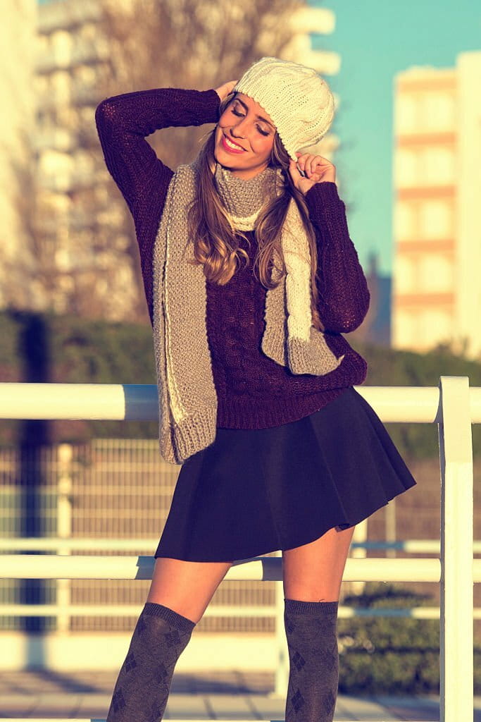 Smiling woman pulling hat
