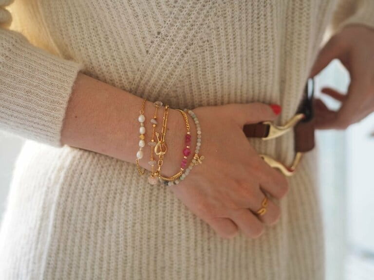 Bracelet Accumulated on a woman's hand over a leather dress and sweater