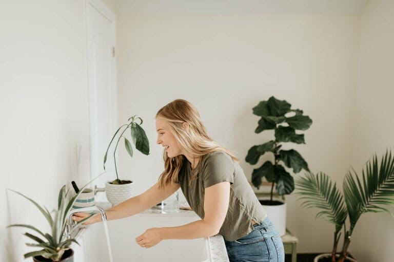 Woman washing hands in sink