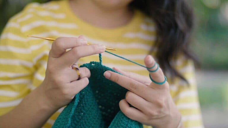 Perspective of knitting with green yarn